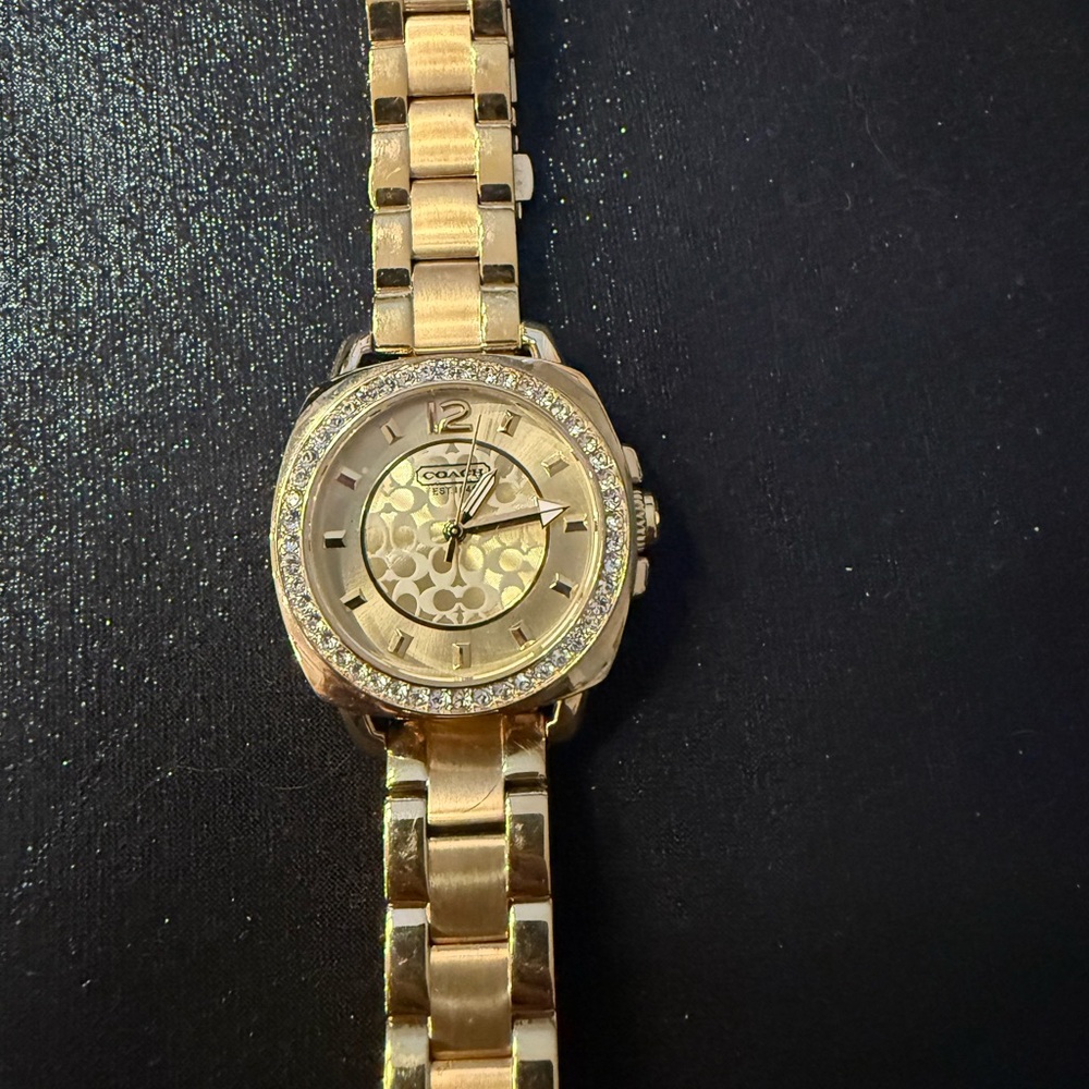 Beautiful Coach insignia gold tone ladies watch with new battery.